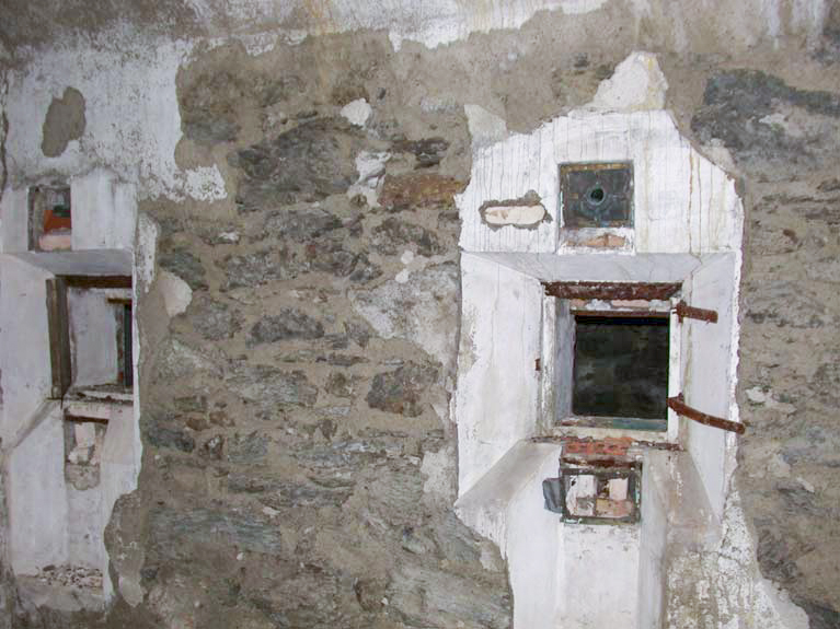 Ligne Maginot - SAPEY (30° DBAF ET 164° RAP) - (PC de Sous-Secteur) - Le système d'éclairage de la poudrière, vu depuis la galerie périphérique.
Les lampes étaient mises en place depuis la galerie, un verre étanche du coté poudrière permettant d'éviter tout contact de la flamme avec une atmosphère pouvant être explosive.
Les trous au dessus des logements des lampes sont les sorties des fumées.